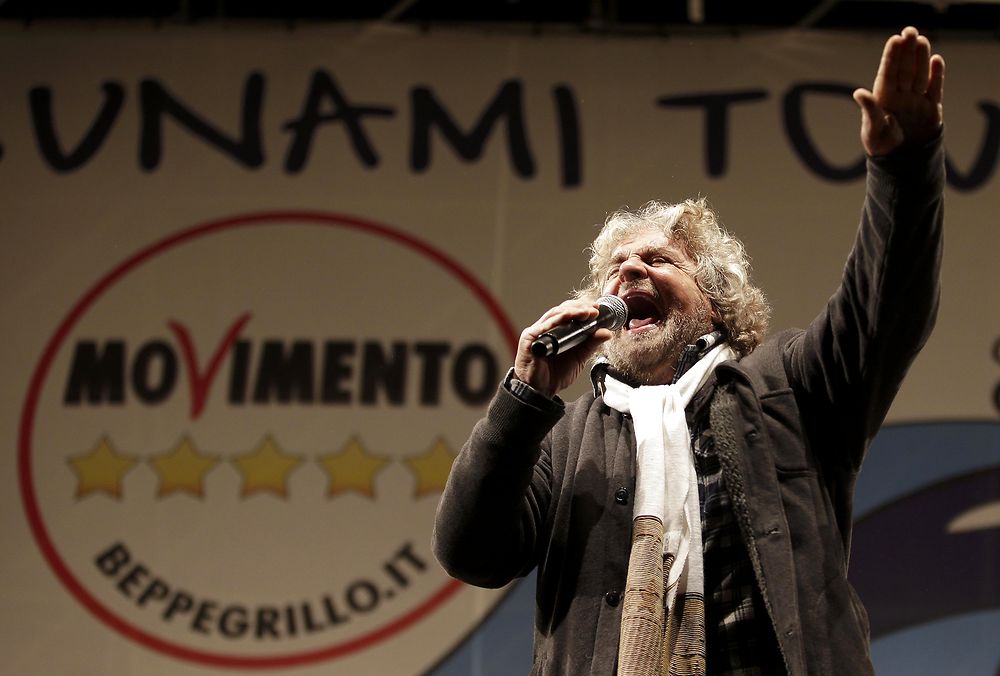Five Star Movement leader and comedian Beppe Grillo (R) speaks during a rally in Rome in this February 22, 2013 file photograph. To match Special Report ITALY-MPS/ REUTERS/Max Rossi/Files (ITALY - Tags: POLITICS ELECTIONS)