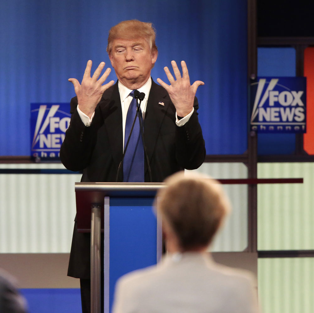 Republican U.S. presidential candidate Donald Trump shows off the size of his hands as Fox News Channel moderators Brett Baier (L) and Megyn Kelly (R) look on at the U.S. Republican presidential candidates debate in Detroit, Michigan, March 3, 2016. REUTERS/Rebecca Cook